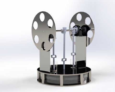 Sterling heteluchtmotor Stalen mechanisme met twee grote schijven en een cilinder in het midden.
